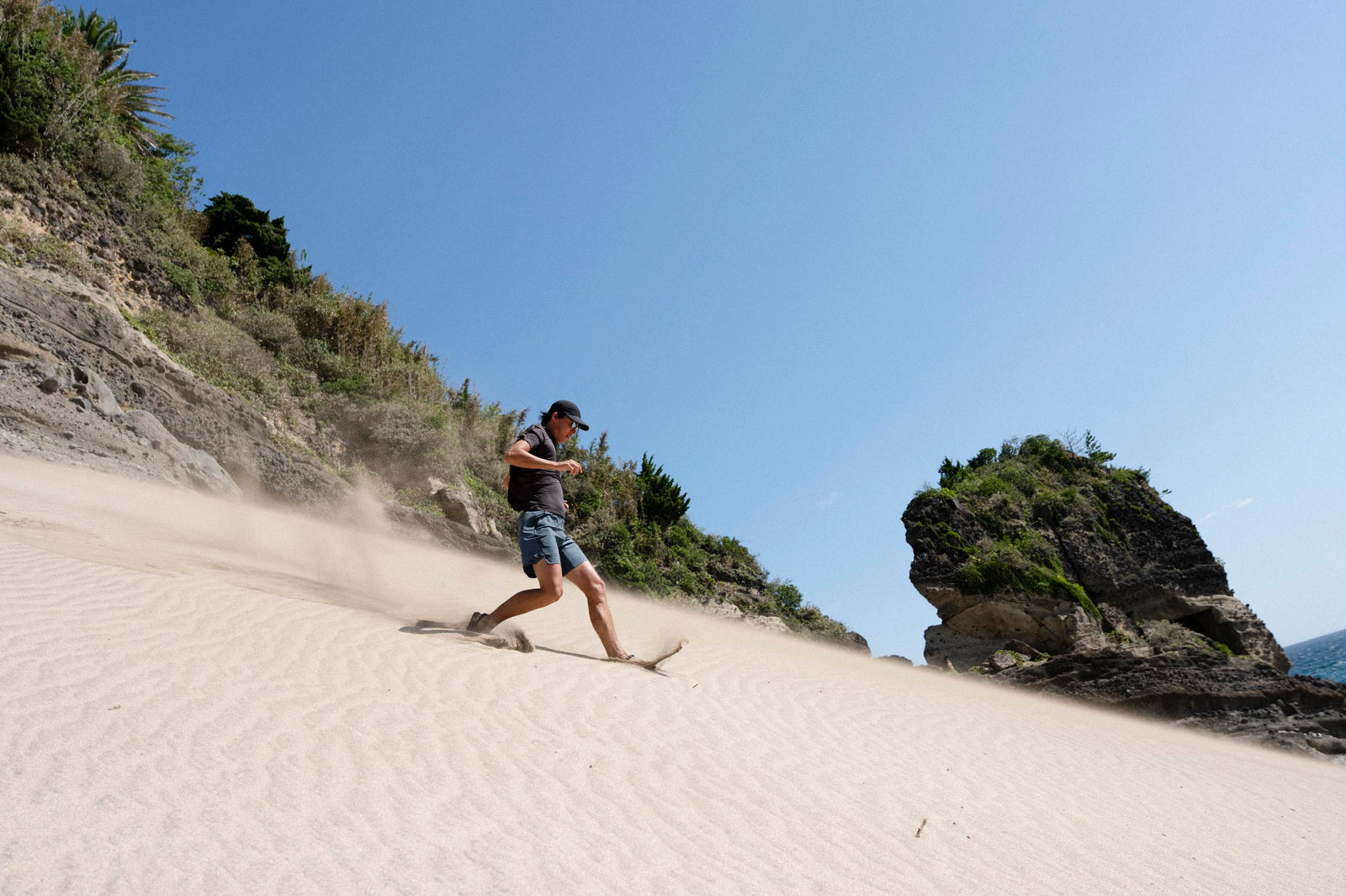 A man runs down sand in Mono