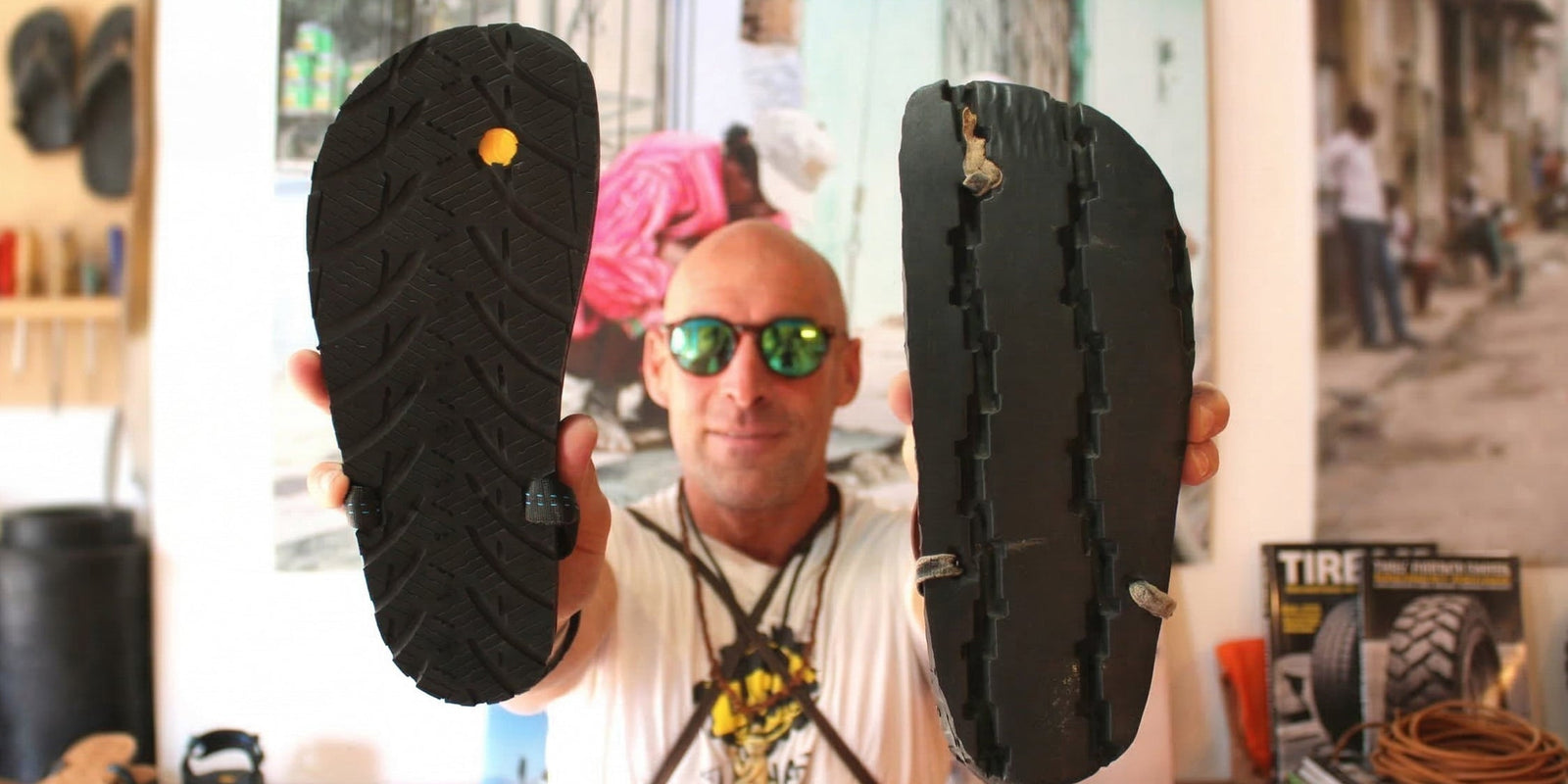 Ted holds up two sandals.