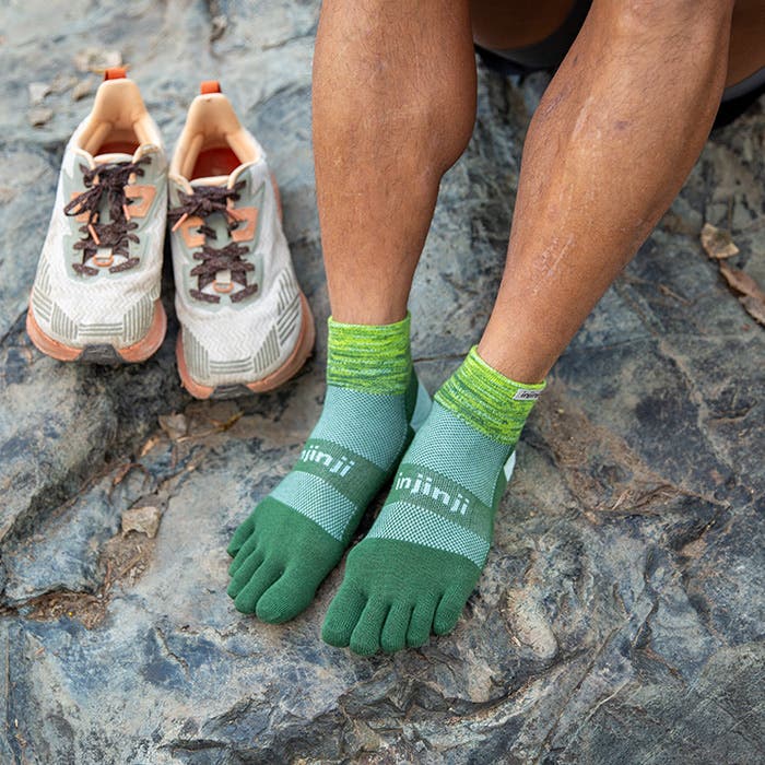 Injinji Toe Socks - Trail Midweight - Basil - worn on rock beside trail shoes