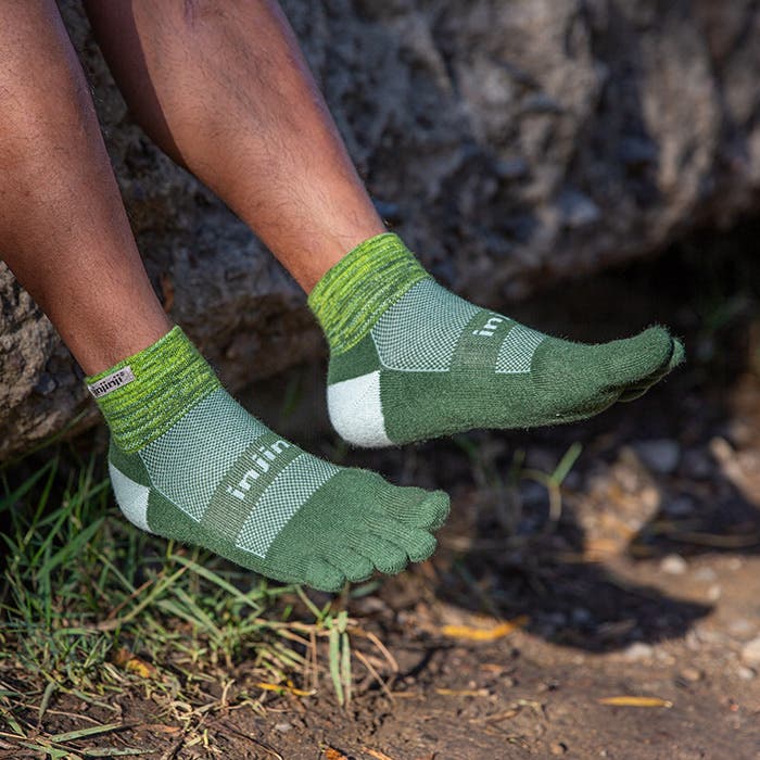 Injinji Toe Socks - Trail Midweight - Basil - crouched on rock