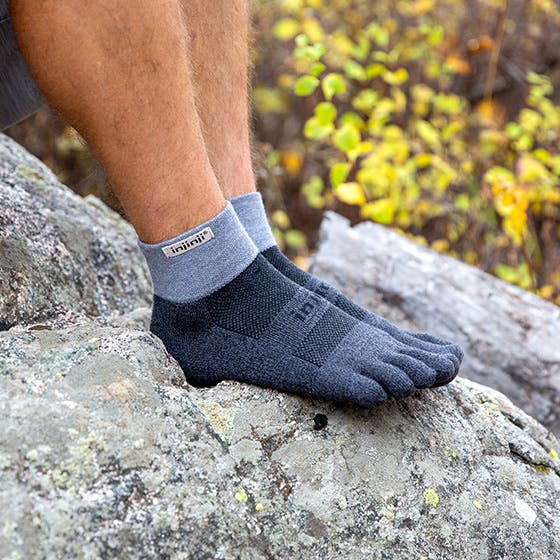 Injinji Toe Socks - Trail Midweight - Granite - stood on a granite boulder