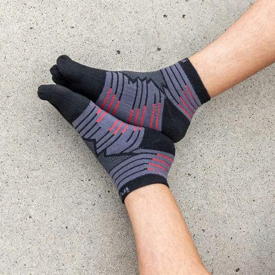 Injinji Toe Socks - Ultra Run Mini Crew - Onyx - putting on, seated